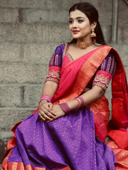 This full-length view shows how the half saree drapes and flows, creating a regal silhouette perfect for any grand occasion.