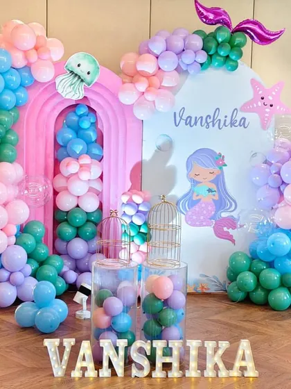 An underwater adventure with this mermaid theme. I used shades of pink, blue, and green, along with mermaid tail and jellyfish balloons, to create a magical ocean scene.