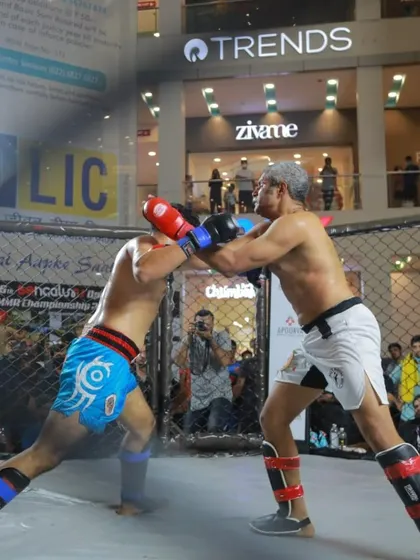 Master Ashwin Naidu in the heat of battle during an MMA championship match. This photo shows his active involvement in the sport, providing our students with a role model who has real-world fighting experience.