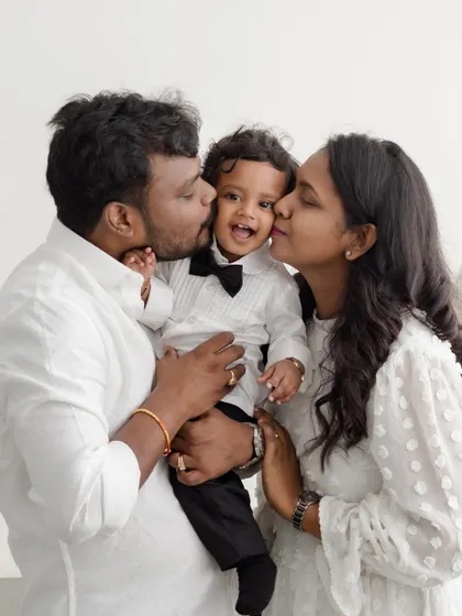There is nothing more heartwarming than capturing the pure love of a new family. The kisses and cuddles in this portrait show the incredible bond that anchors a family from the very beginning.