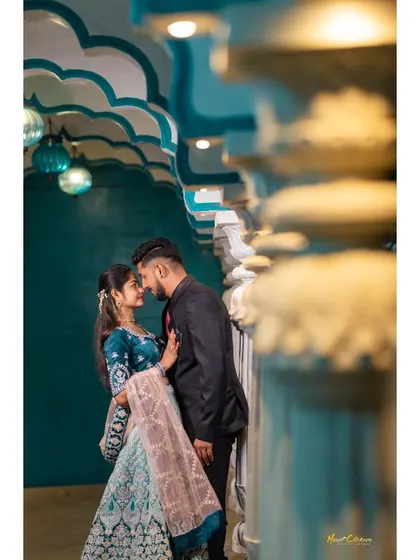 An intimate pre-wedding portrait in a beautifully lit, ornate corridor. The architecture and lighting add a sense of grandeur and romance.