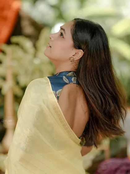 This view showcases the stunning back of the custom-designed blouse paired with my yellow saree. It's a perfect example of how to create a complete, stylish look.