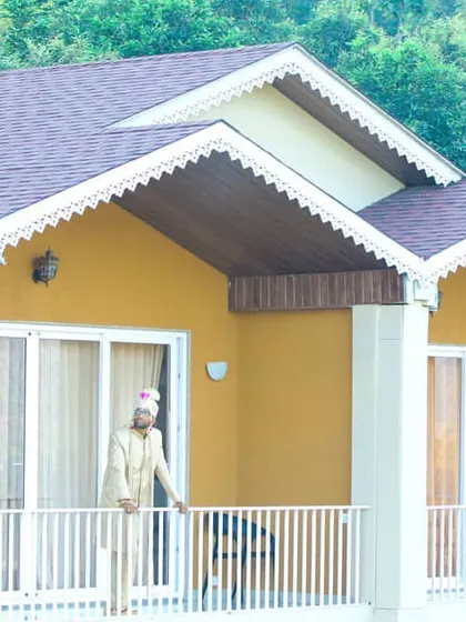 A portrait of the groom in his wedding sherwani, standing on the balcony of a beautiful villa, awaiting the start of the ceremonies.