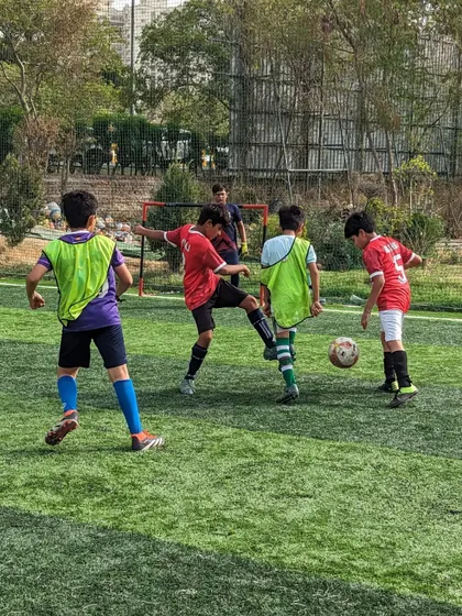 Close-quarters defending during the U10 friendly match, demonstrating the importance of tight marking.