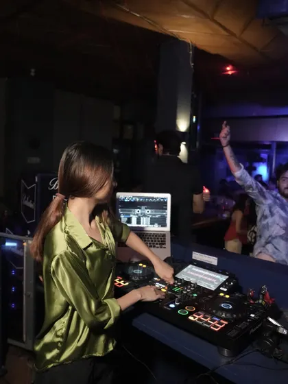Another angle from the Dehradun night, showing a guest enjoying the music. My goal is to connect with the audience through my tracks.