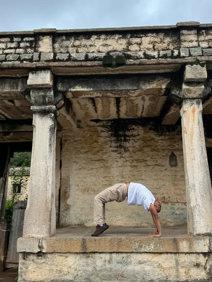 In the quiet of an old stone temple, I practice Chakrasana, the wheel pose. These moments remind me to stay humble, keep learning, and find inspiration in the history and nature around us.