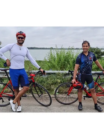 A post-ride photo with a client by the lake. We train hard, but we also enjoy the journey and the beautiful scenery.