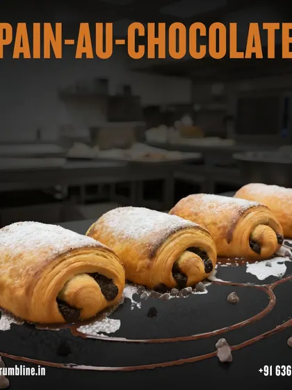 Pain au chocolat sits in our pastry catalogue image, with the chocolate filling visible at each rolled end.