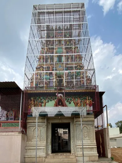 An interesting observation of a geometric mesh enclosure around a traditional temple gopuram in Devanahalli. It creates a curious juxtaposition of modern engineering and historic craftsmanship.