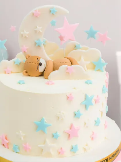 A close-up of the adorable sleeping bear and starry details, perfect for a baby shower or first birthday.