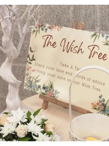 A 'Wish Tree' installation, an interactive element for guests. We provide a beautifully decorated tree where guests can hang their well wishes and notes of advice for the couple, creating a memorable keepsake.