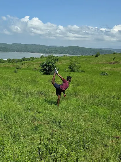 Practicing Natarajasana (Dancer's Pose) in a field in Gokarna. For me, setting a stage for practice is like worshipping the body, finding beauty in the movement and the surroundings.