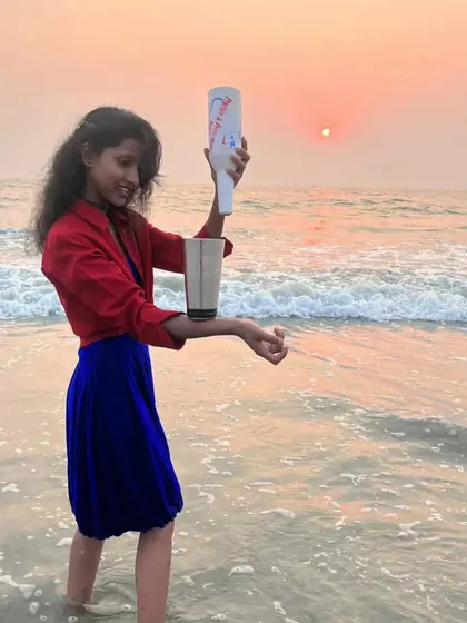 A flair bartender practicing her balance and skill at sunset on the beach. This is the dedication that defines our team.