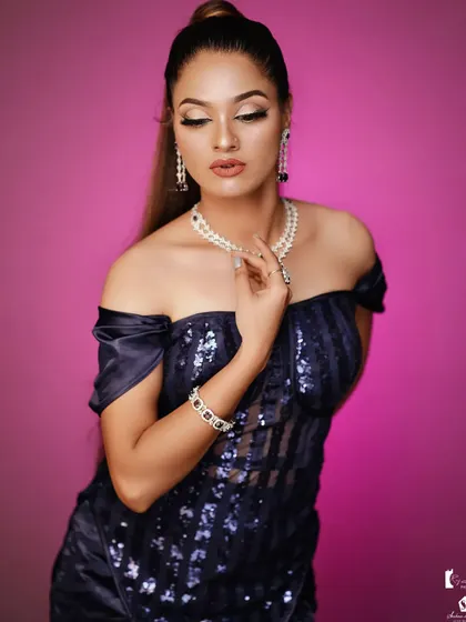 A glamorous party look with an off-shoulder sequined dress and a high ponytail.