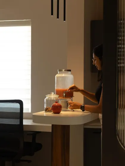 A team member using the pantry, demonstrating the practical and accessible design of the break area.