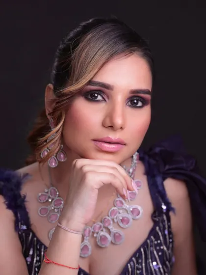 A glamorous reception look with smokey eyes and statement diamond and ruby jewelry.