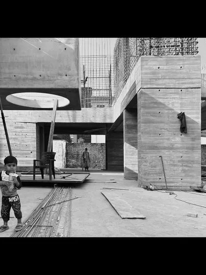 A moment during the construction of the Moradabad villas, showing the scale of the concrete forms and a circular skylight opening.