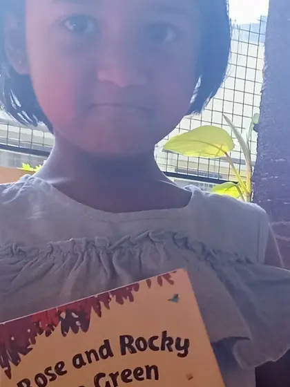 A girl holding her favorite picture book.