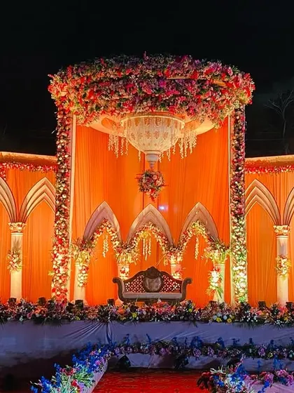 The royal palace stage seen during the day, showcasing the intricate details of the arches and the vibrant floral arrangements.