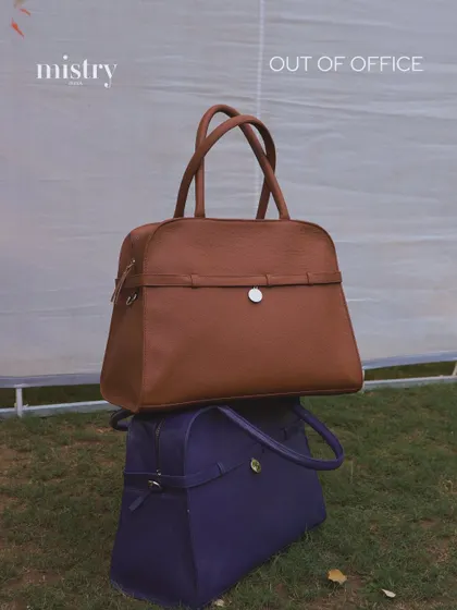 Introducing the Carryall, our ultimate 'giant tote' for when you need to carry it all. Stacked here in Pebbled Terra and Parisian Blue, these bags are designed for the modern woman who is never truly out of office and always in style.