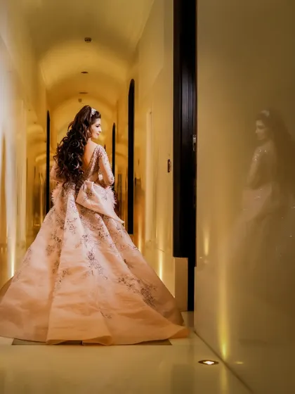 A back view of the bride's spectacular gown, showing off the large bow and intricate embroidery. We ensure that every detail of the bridal outfit is beautifully documented.