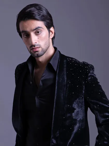 A confident portrait in the black velvet jacket. This piece is all about adding a touch of glamour to a classic menswear staple.