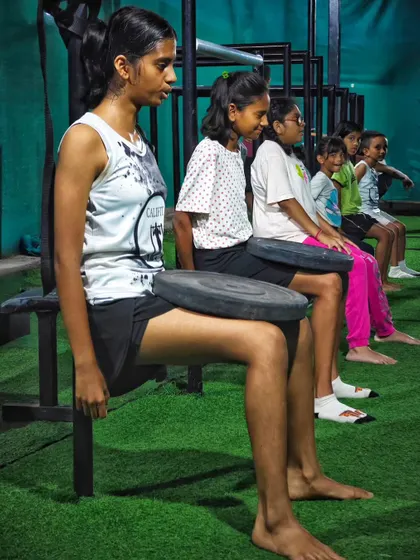 Building leg and core endurance with wall sits. Our girls train together, motivating each other to hold on for just a little longer.