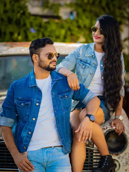 Posing with a vintage Ambassador car, this couple's pre-wedding photo has a cool, retro vibe. We love incorporating unique props that reflect your personality.