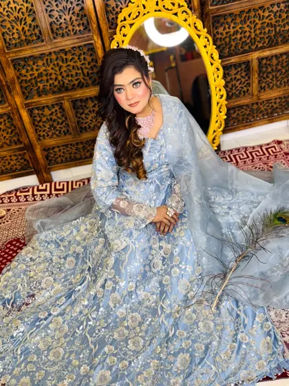 A full-length view of this gorgeous soft glam look. The light blue embroidered outfit is beautifully complemented by the subtle makeup and soft curls.