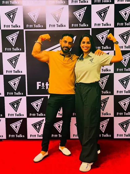 At a Fitt Talks event, building strength and smashing goals with a fellow fitness enthusiast. It's all about sharing knowledge and inspiring others.