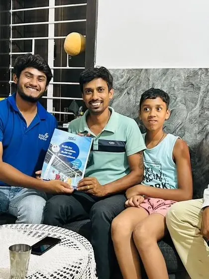 A family with a young boy holding our solar booklet, learning about clean energy early.