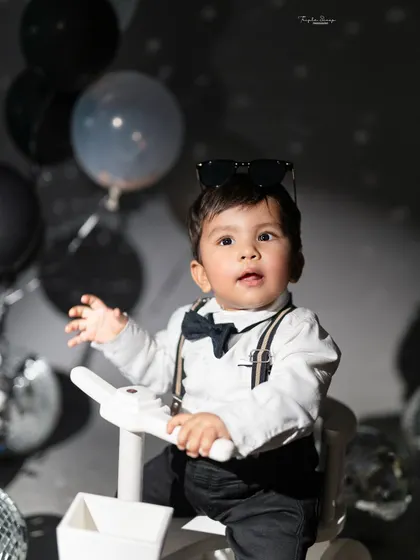 A cool little dude in a dapper outfit. The disco theme with dramatic lighting creates a fun and stylish portrait with a lot of personality.