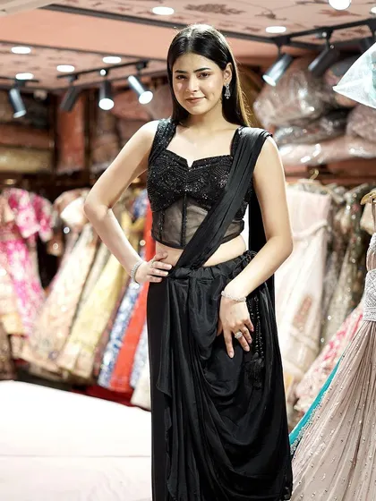 Step into the spotlight with this sleek black pre-draped saree and blouse. A chic ensemble for a seamless fusion of tradition and modernity.