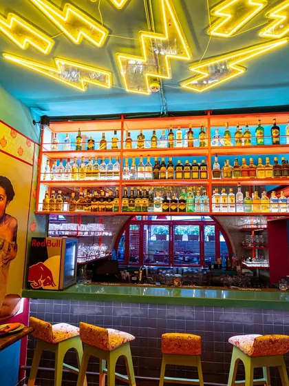 The lightning bolt neon installation at The Fatty Bao's bar is a key design feature. I shot this to emphasize the dramatic lighting and how it interacts with the fully stocked bar, creating a visually exciting focal point.