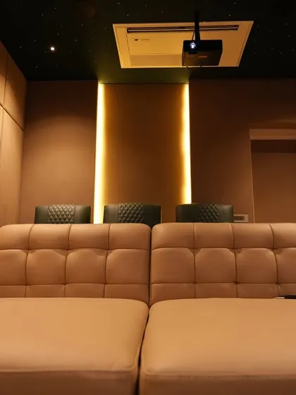 The view from the daybed, looking towards the back of the room. The warm, indirect lighting and padded walls create a cozy and acoustically balanced environment.