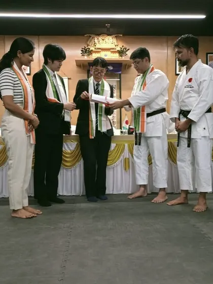 A proud moment as a student receives their certification during our JKA seminar, with representatives from the Consulate General of Japan present.