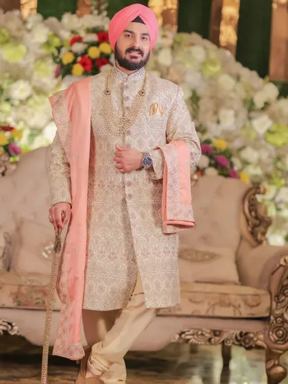 A classic portrait of the groom in his elegant sherwani, looking poised and ready for the ceremony.