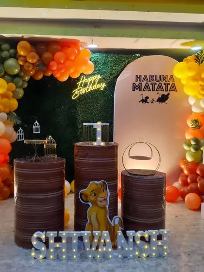 We designed this simple and sweet Lion King theme for Shivansh's first birthday. It features a greenery backdrop, a "Hakuna Matata" sign, and an earthy-toned balloon arch with character cutouts.