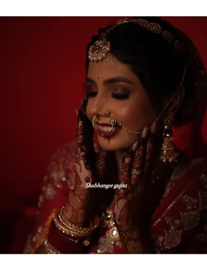A happy bride showing off her gorgeous, dark mehndi stain on her wedding day. This is the beautiful result after the henna paste has been removed and the color has matured.