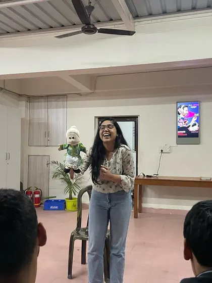 A participant in a corporate workshop discovers her inner puppeteer. My sessions for teams are about experimenting, playing, and finding the joy in a new skill, which is a fantastic way to build camaraderie.
