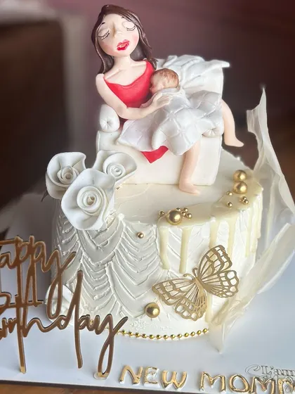 Celebrating the sweetest chapter yet. Our custom new mommy cake is baked with love, featuring a tender moment between a mother and her newborn, to make her birthday extra special.