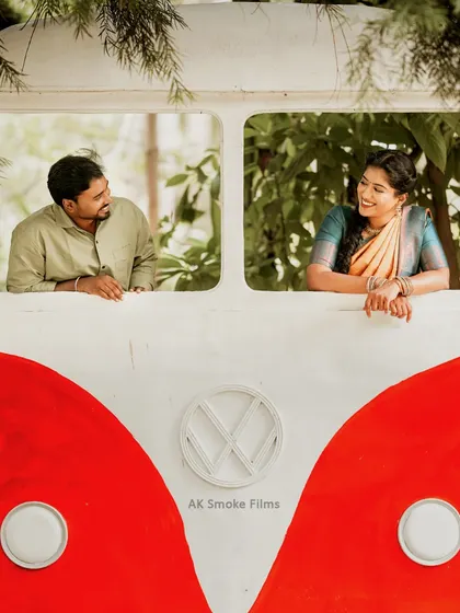 A fun and quirky pre-wedding shot using a vintage VW bus prop, perfect for couples looking for something unique.