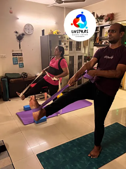 Two clients use resistance bands to deepen their leg stretches and improve balance.