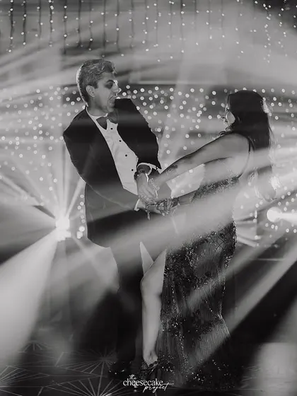 A creative, motion-blur shot of the couple's first dance, capturing the movement and the stunning light display.
