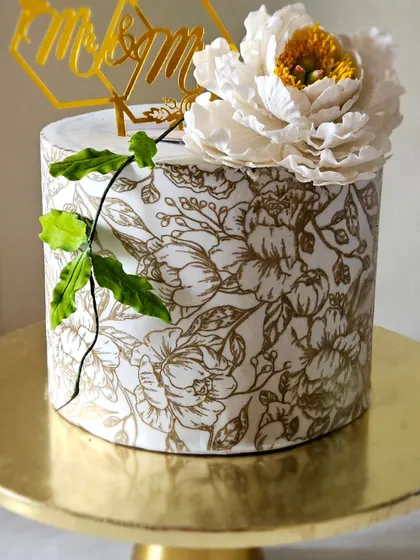 Another angle of the peony and stencil cake, showing the clean lines and the beautiful contrast between the gold pattern and the white fondant.