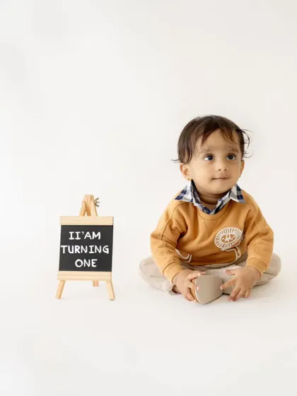 A simple and sweet announcement: "I'm turning one!" The chalkboard sign is a great prop to mark this special milestone.