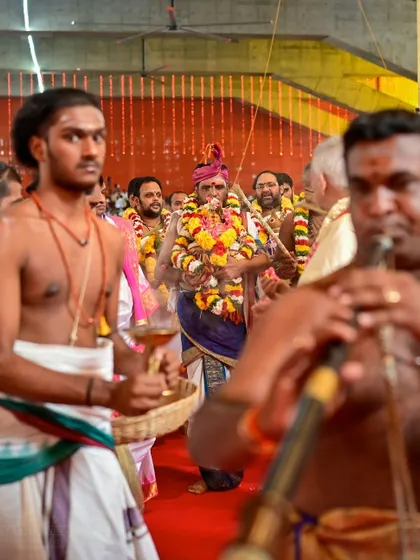 A procession during the Rishi Homa. The priests carry sacred items with reverence, and the air is filled with the sound of traditional music and chants.
