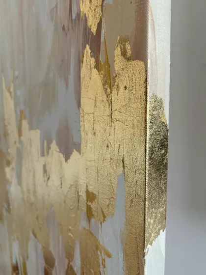 A side view of a finished abstract canvas, showing how the gold leaf wraps around the edge. This gives the artwork a polished, three-dimensional feel even without a frame.