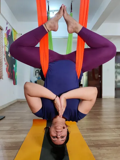 This inverted Baddha Konasana in the aerial hammock is a beautiful expression of openness and surrender, allowing gravity to deepen the pose.