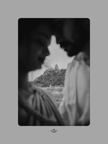 An artistic black and white shot with the Melkote temple in the background. The selective focus creates a dreamy, intimate portrait while still honoring the sense of place.